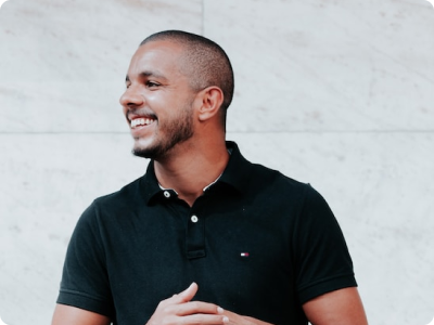 Man smiling in black polo