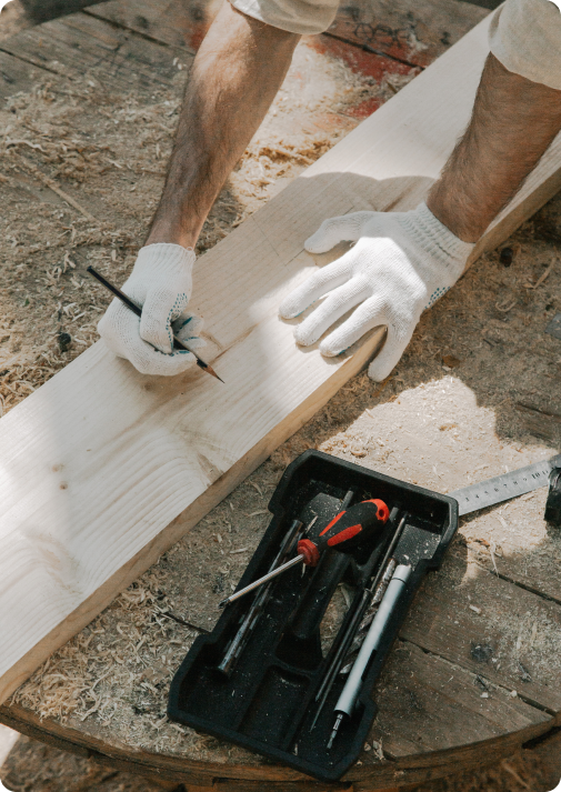 Carpenter measuring plank of wood