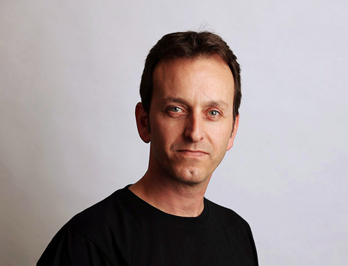Eran smiling in black shirt