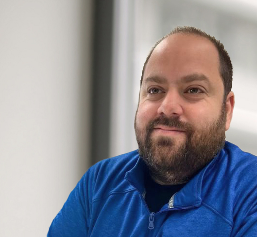 Man in blue shirt smiling