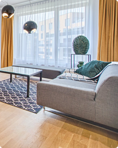 Luxury living room with grey couch and hardwood floor